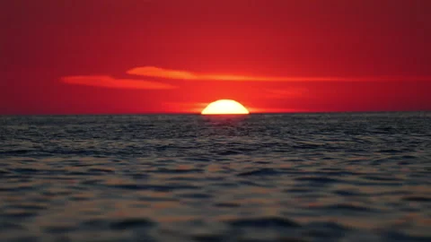 Dramatic red sunset over Mediterranean sea, large sun on horizon, 4K slow motion Stock Footage 334128851