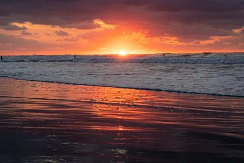 Dramatic Red Sunset Over North Sea Waves  Fiery Orange Sky Reflecting on We.. Stock Photos