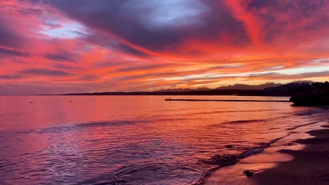 Dramatic red sunset reflecting on calm sea waves Stock Footage 343576958