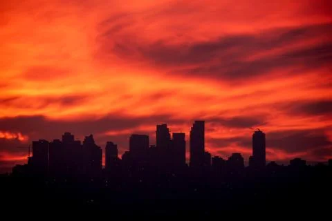 Dramatic Red Sunset Silhouette of Modern City Skyline Stock Photos