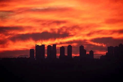 Dramatic Red Sunset Silhouette of Modern City Skyline Stock Photos
