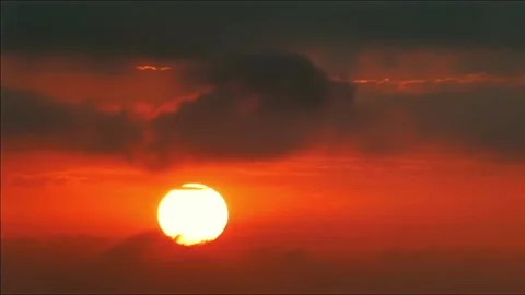 Dramatic Red Sunset Sky with Dark Clouds and Bright Sun Stock Footage 323103944
