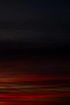 Dramatic Red Sunset Sky with Dark Clouds Stock-Fotos
