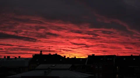 Dramatic Red Sunset Sky Over City Rooftops Silhouette Stock Photos