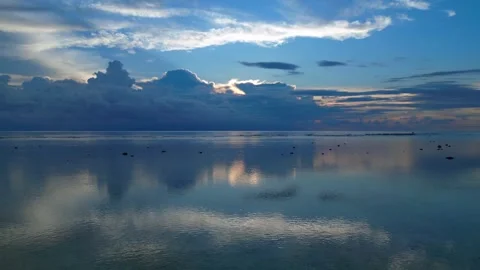 Dramatic Reflecting cloudy sky over calm ocean waters. Magic aerial view drone Stock Footage 340794651