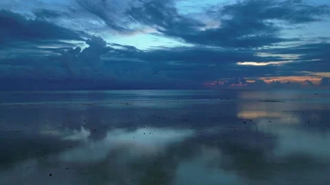 Dramatic Reflecting cloudy sky over calm ocean waters. Smooth aerial view drone Stock Footage 344617392