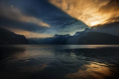 Dramatic reflection in the sky and clouds during sunset at lake Stock Photos