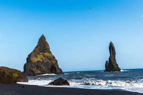 The dramatic Reynisfjara Beach features black volcanic sands and towering b.. Stock Photos