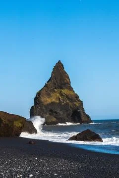 The dramatic Reynisfjara Beach features black volcanic sands and towering b.. Stock Photos