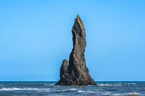 The dramatic Reynisfjara Beach features black volcanic sands and towering b.. Stock Photos