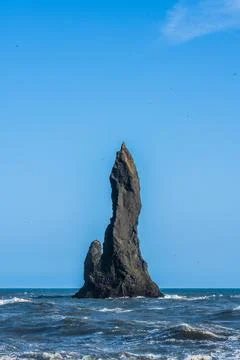 The dramatic Reynisfjara Beach features black volcanic sands and towering b.. Stock Photos