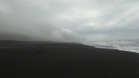Dramatic Reynisfjara black sand beach under stormy clouds, Iceland Vídeos de archivo 334336174