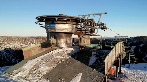 Dramatic Rising Aerial Over Old Chairlift on Sunny Winter Day Aerial 4K Stock Footage 137878134