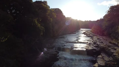 Dramatic rising shot over river with waterfalls and rapids Stock Footage 292132331