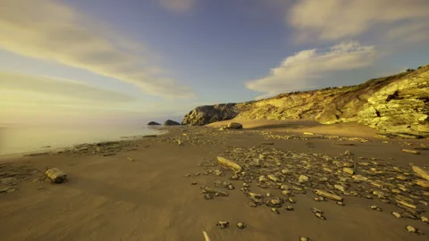 Dramatic riverbank with textured rocks and expansive cloud formations Stock Footage 335594373