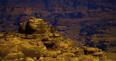 Dramatic rock formation against layered landscape in desert canyon Stock Illustration