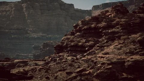 Dramatic rock formations against a rugged landscape in desert terrain Illustrazione stock