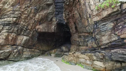 Dramatic Rock Formations and Sea Cave on a Sandy Beach 스톡 동영상 336452737