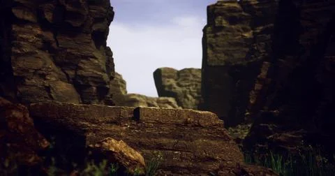 Dramatic rock formations contrast against a clear sky in rugged terrain Stock-Illustration