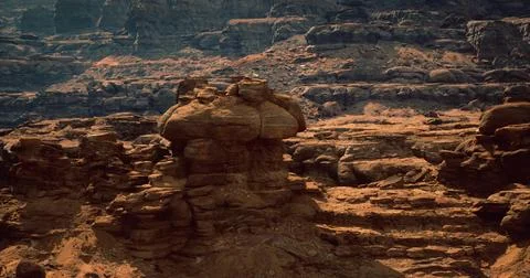 Dramatic rock formations in a desert landscape under soft sunlight Stock Illustration