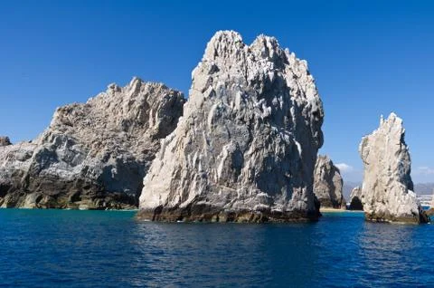 Dramatic rock formations jut from the pacific ocean Stock Photos