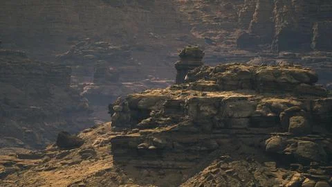 Dramatic rock formations rise majestically under the fading light of dusk Stock Illustration