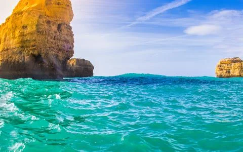 Dramatic rock formations rise majestically from the vibrant turquoise water.. Stock Photos