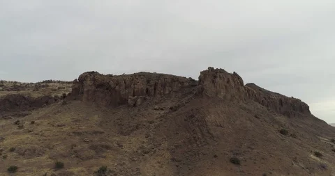 Dramatic rocks on top of mountain wide orbit drone aerial 4K Stock Footage 111315918