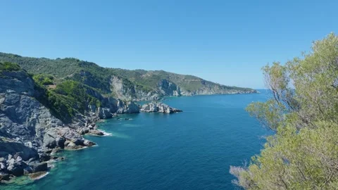 The dramatic rocky coastline and clear blue waters near Agios Ioannis Kastri Stock Footage 346664786