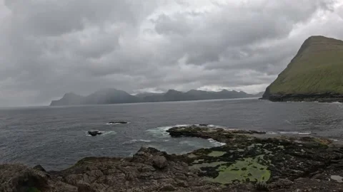 Dramatic rocky coastline and rough ocean waves in Faroe Islands Stock Footage 340026877