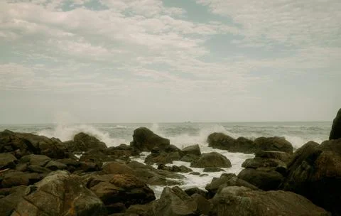 Dramatic Rocky Coastline with Waves Crashing on Shore Stock Photos