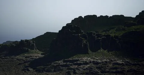 Dramatic rocky landscape under clear sky at dawn with soft lighting effects Stock Illustration