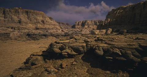 Dramatic rocky landscape under cloudy sky in a remote desert area 스톡 일러스트