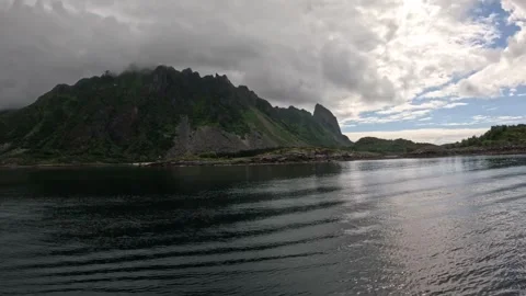 Dramatic rocky mountain peak with flying seagulls in Norwegian fjord Stock-Footage 344047606