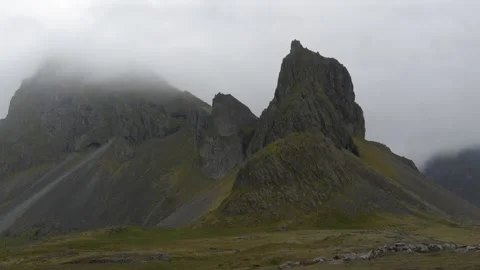 Dramatic rocky mountain peaks in misty Icelandic landscape 4K nature footage Stock Footage 339925346