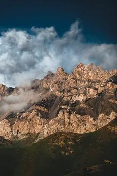 Dramatic rocky mountain summit glowing in warm sunlight Photos
