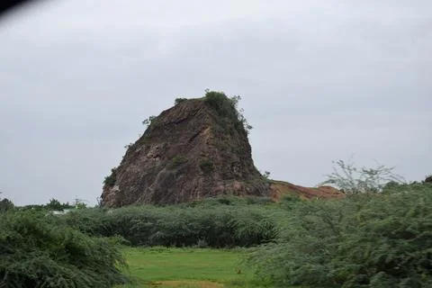 Dramatic Rocky Outcrop Surrounded by Vegetation Stock Photos
