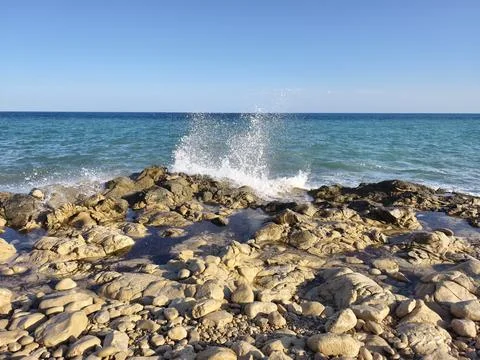 Dramatic rocky sea splash, dynamic ocean wave colliding with rugged coastline in Stock Photos