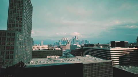 Dramatic rooftop perspective showcasing urban structures and cloudy sky Stock Footage 327615214