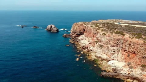 Dramatic sandstone cliffs dominate seascape view, scenic aerial perspective of Stock Footage 321453531