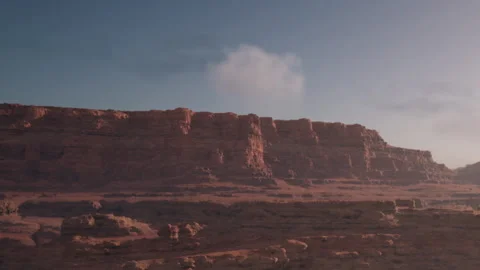 Dramatic Sandstone Cliffs Rise Majestically Under a Clear Blue Sky Stock Footage 346688988