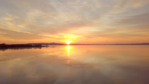 Dramatic scene of beautiful sunrise over a calm lake. Stock Footage 101519851