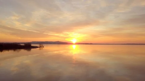 Dramatic scene of beautiful sunrise over a calm lake. Stock Footage 101519913