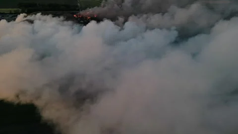 Dramatic scene of large plume of smoke rising from a fire Stock Footage 345440841