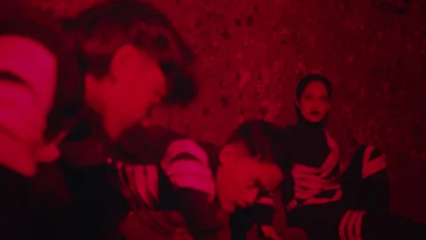 Dramatic Scene with Red Lighting and Stylish Outfits Stock Footage 296679493