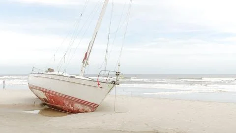 Dramatic Scene of a Yacht Stranded on a Sandy Beach After a Destructive Hur.. Stock Photos