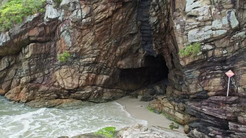 Dramatic Sea Cave with Waves on Sandy Beach - Natural Coastal Wonder 스톡 동영상 336452702