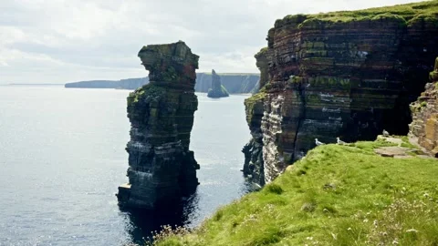 Dramatic Sea Stacks and Rugged Green Cliffs Along Jurassic Coast Near Old Harry Stock Footage 346598413