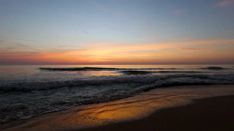 Dramatic sea sunrise. Burning sky and shining golden waves. Stock Footage 163614843