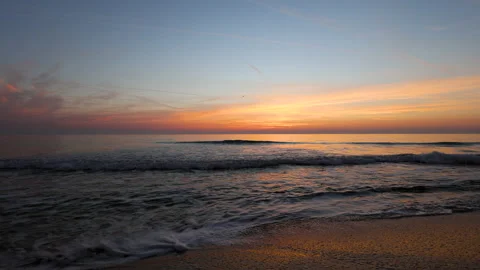 Dramatic sea sunrise. Burning sky and shining golden waves. Stock Footage 163650153